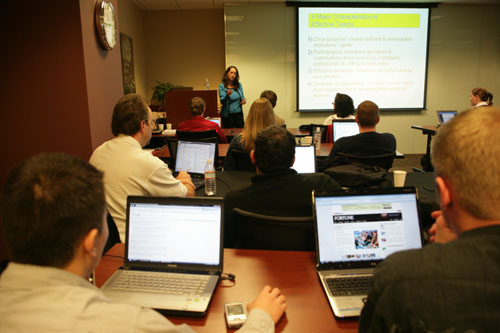 Instructor lecturing business students in classroom