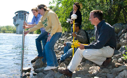 Students and instructor taking scientific readings Students and instructor taking scientific readings
