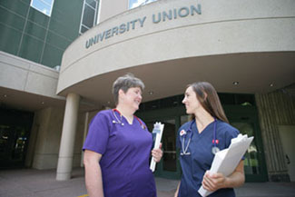 Nursing students standing in front of the University Union