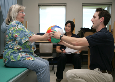 Physical Therapy students working with patient